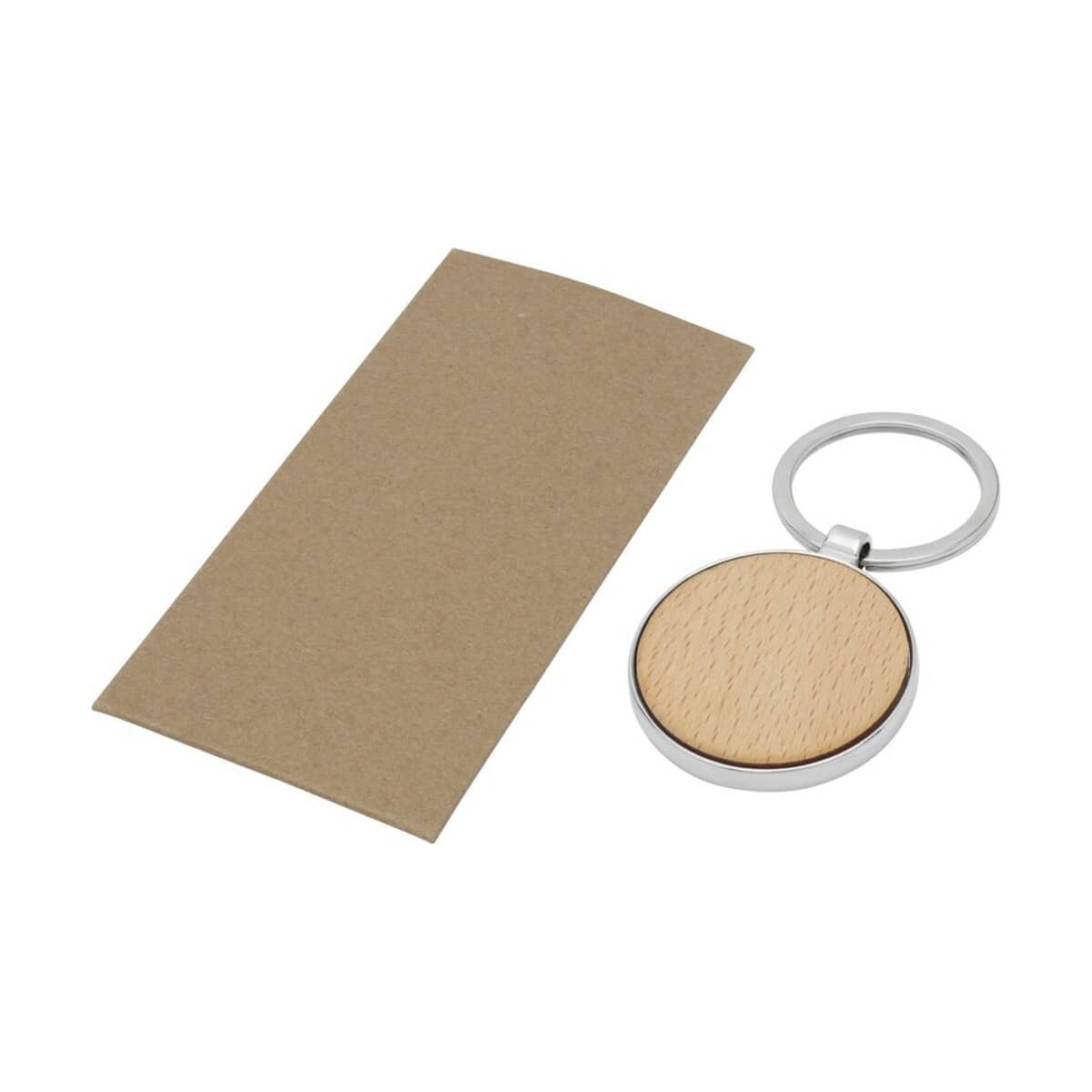 Breloki wielofunkcyjne z logo – okrągły brelok do kluczy moreno z drewna bukowego 11812371_e1 Metalowy brelok z drewnianym elementem personalizacji, idealny na gadżet reklamowy.